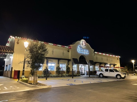Commercial restaurant building outlined with Christmas lights at night